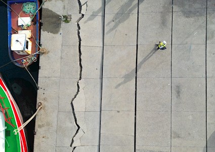 Large cracks in the pavement of a fishery; the ground moved 1 to 2 feet.