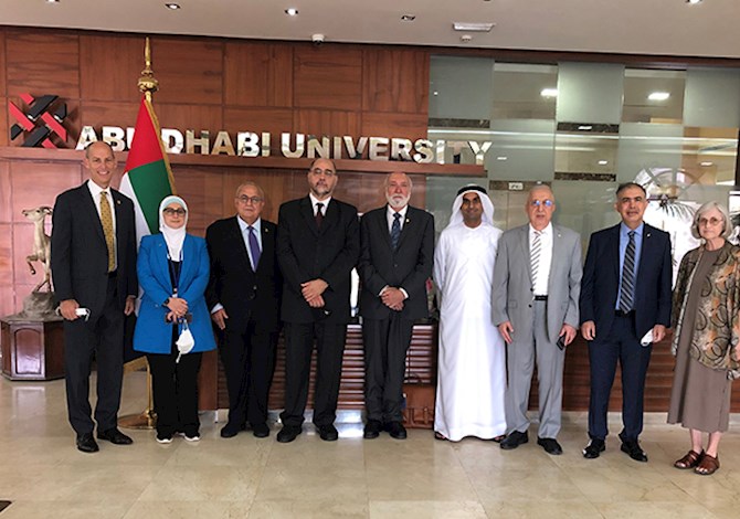 ASCE and ASCE UAE Section Leaders and hosts met in Abu Dhabi, UAE in September 2022. Pictured are nine people standing inside Abu Dhabi University, smiling at the camera.