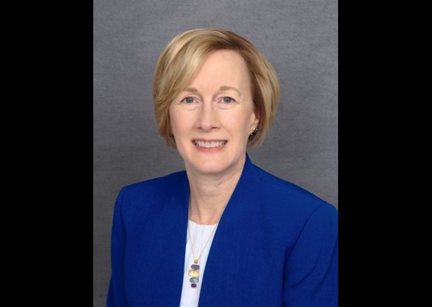 Portrait of Deborah Lee - blonde woman in blue suit jacket smiling at camera