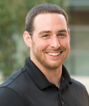 Portrait of Francis Mahaney - man in black shirt smiling at camera