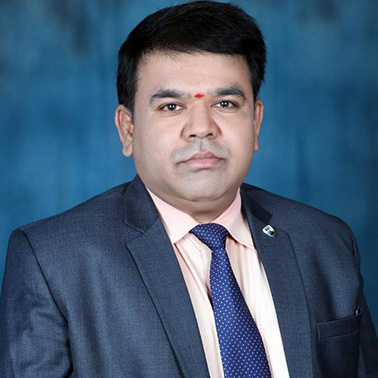 Portrait of Narsimha Chary Poloju - a man wearing a blue suit smiles