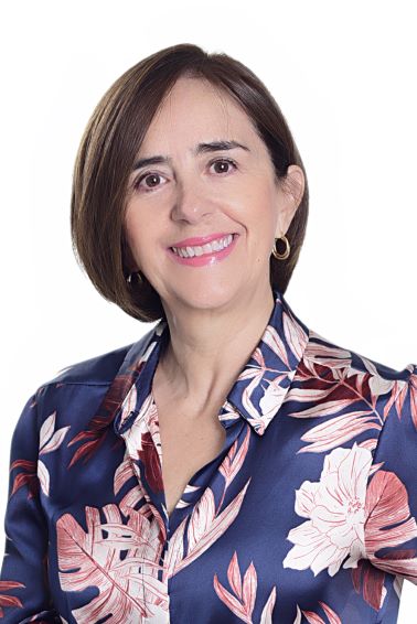 Woman wearing floral blouse smiling at camera