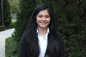 Image of Isamar Escobar: Young brunette woman in dark jacket smiling at the camera