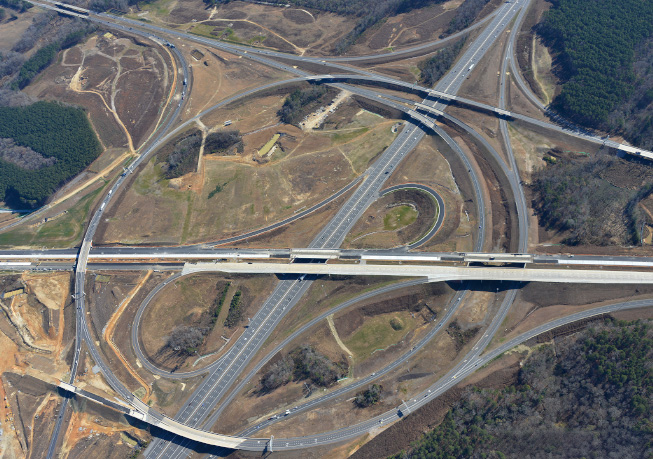 Aerial view of the Complete 540 Phase 1 highway interchange, showing multiple elevated ramps and connecting roadways.