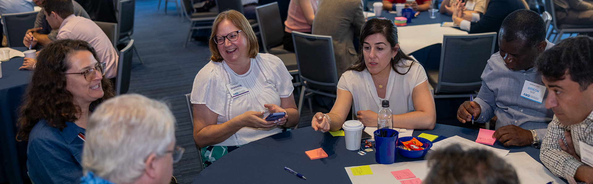attendees at a table having a conversation