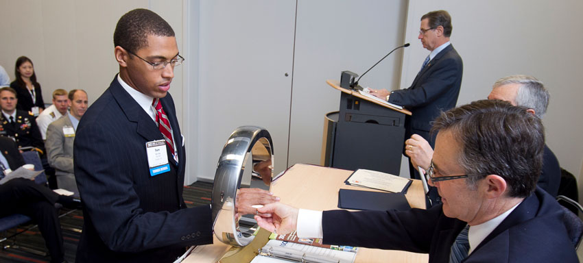 Sam Oke receives the Order of the Engineer ring from President DiLoreto