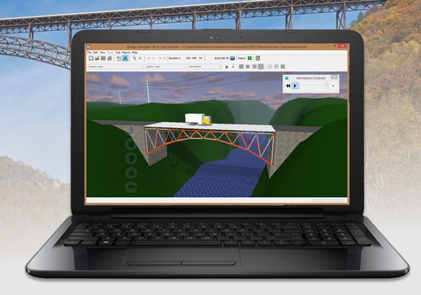 Laptop with program open on it showing truck driving over bridge