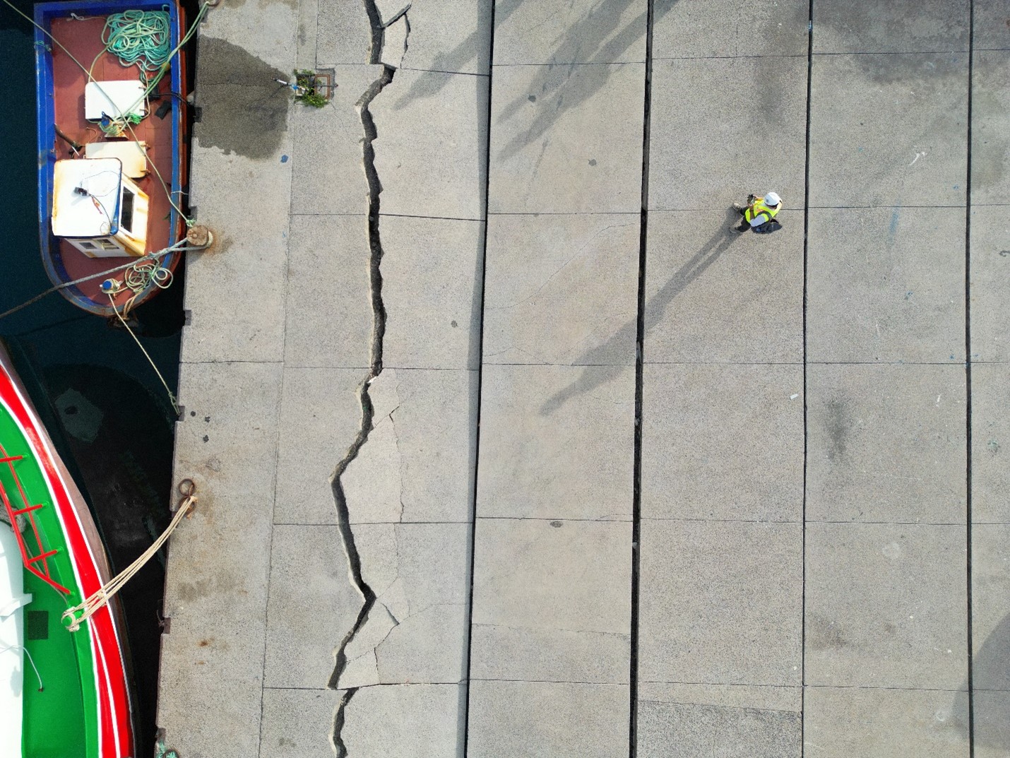 Large cracks in the pavement of a fishery; the ground moved 1 to 2 feet.