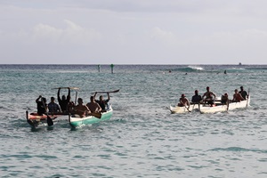 Two teams finish a race on Duke’s Beach