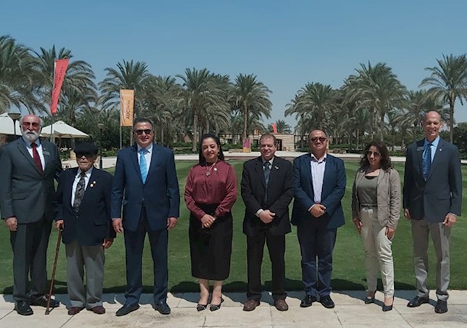 ASCE and ASCE Egypt Section Leaders met in Cairo, Egypt on September 2022. Pictured are eight people standing outside smiling in front of Cairo University on a sunny day.