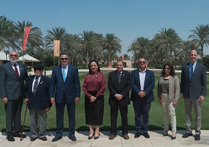 ASCE and ASCE Egypt Section Leaders met in Cairo, Egypt on September 2022. Pictured are eight people standing outside smiling in front of Cairo University on a sunny day.