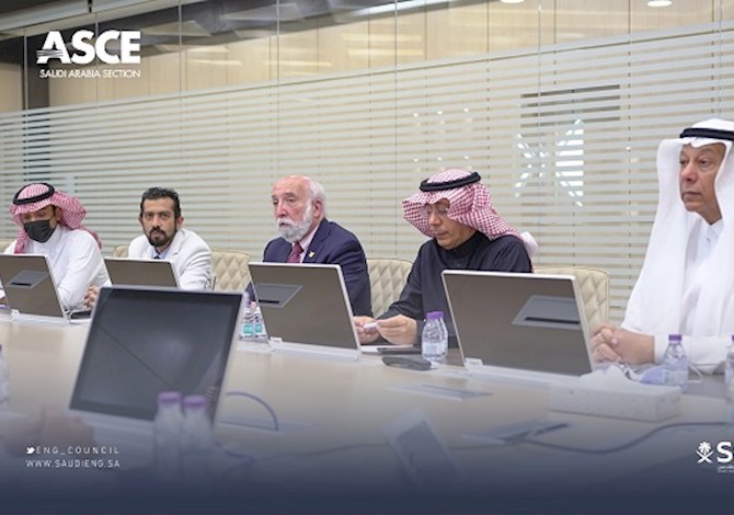 President Truax with the Saudi Council for Engineers (SCE). Pictured are 5 people sitting in front of laptops. 