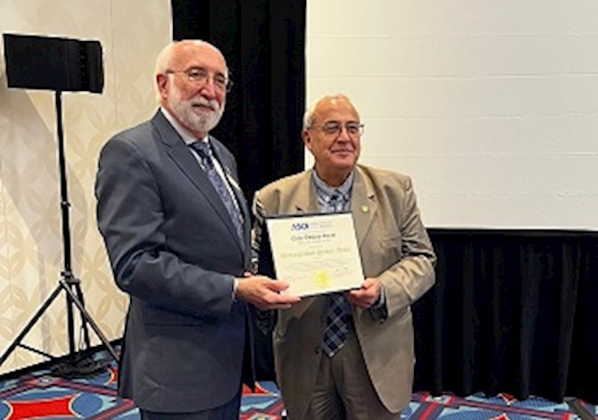 President Truax and Dr. Elias at the Global Reception of the ASCE 2022 Convention. Pictures are 2 people standing holding an award smiling at the camera