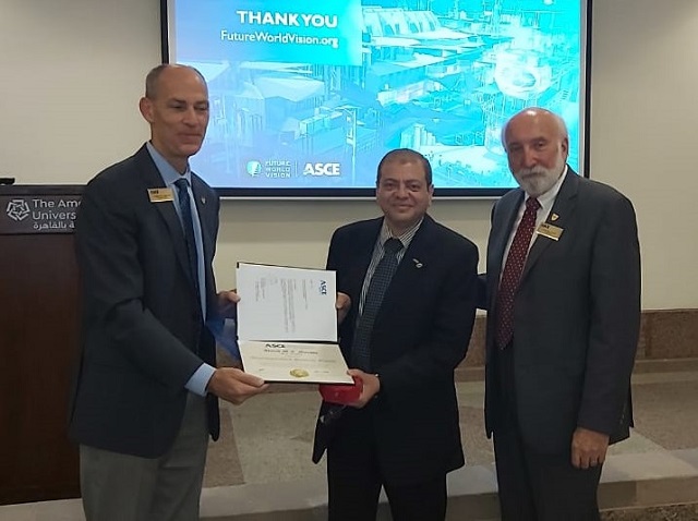 Dr. Moussa with President Truax and Executive Director Smith in Cairo, Egypt. Pictured are three people looking at the camera smiling. Two of them are holding the award. 