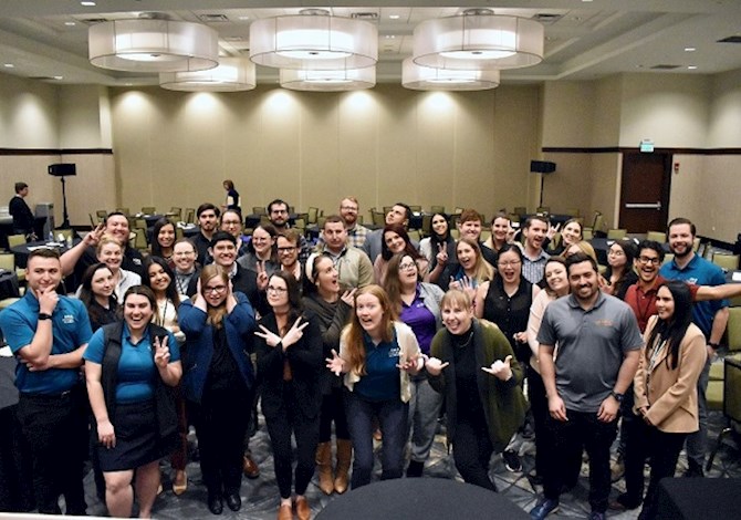 MRLC 2023 Younger Member Council group photo. Pictured are 36 people facing the camera making funny faces in a banquet hall.