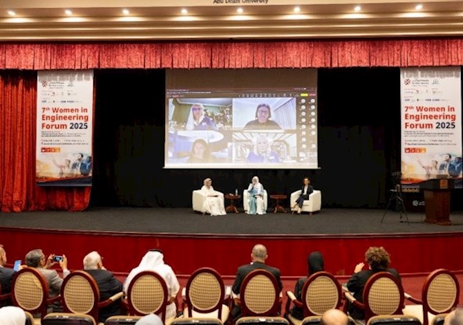 3 Speakers seated on state at Panel Discussion