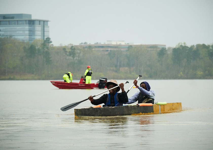 Student members in a canoe at ASCE Concrete Canoe Competition.