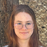 young woman with brown hair and glasses