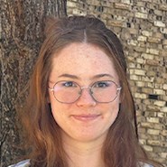 young woman with brown hair and glasses