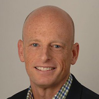 man in blue check shirt and blue jacket