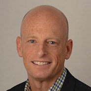 man in blue check shirt and blue jacket