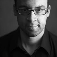 Man in black shirt with glasses