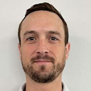 Man smiles at the camera.