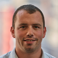 Man smiles at the camera.