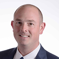 man in suit smiling at camera