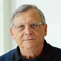 Man looks at the camera with a serious expression on his face.