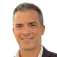 Man smiles at the camera.