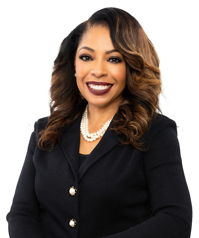 A woman smiles at the camera.