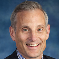 Man in suit and checked shirt