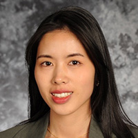 Woman in suit and white blouse