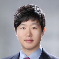 Man in blue suit and blue oxford shirt with a tie