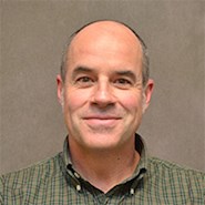 Man smiles at camera.