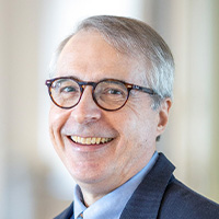 Man in jacket and tie with glasses.