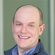 Man smiles at camera.