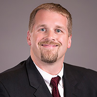 man in suit smiling at camera