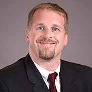 man in suit smiling at camera