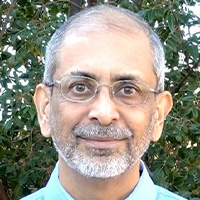 Man in blue shirt and glasses