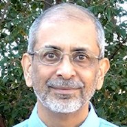 Man in blue shirt and glasses