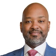 man wearing a light blue suit with a patterned tie