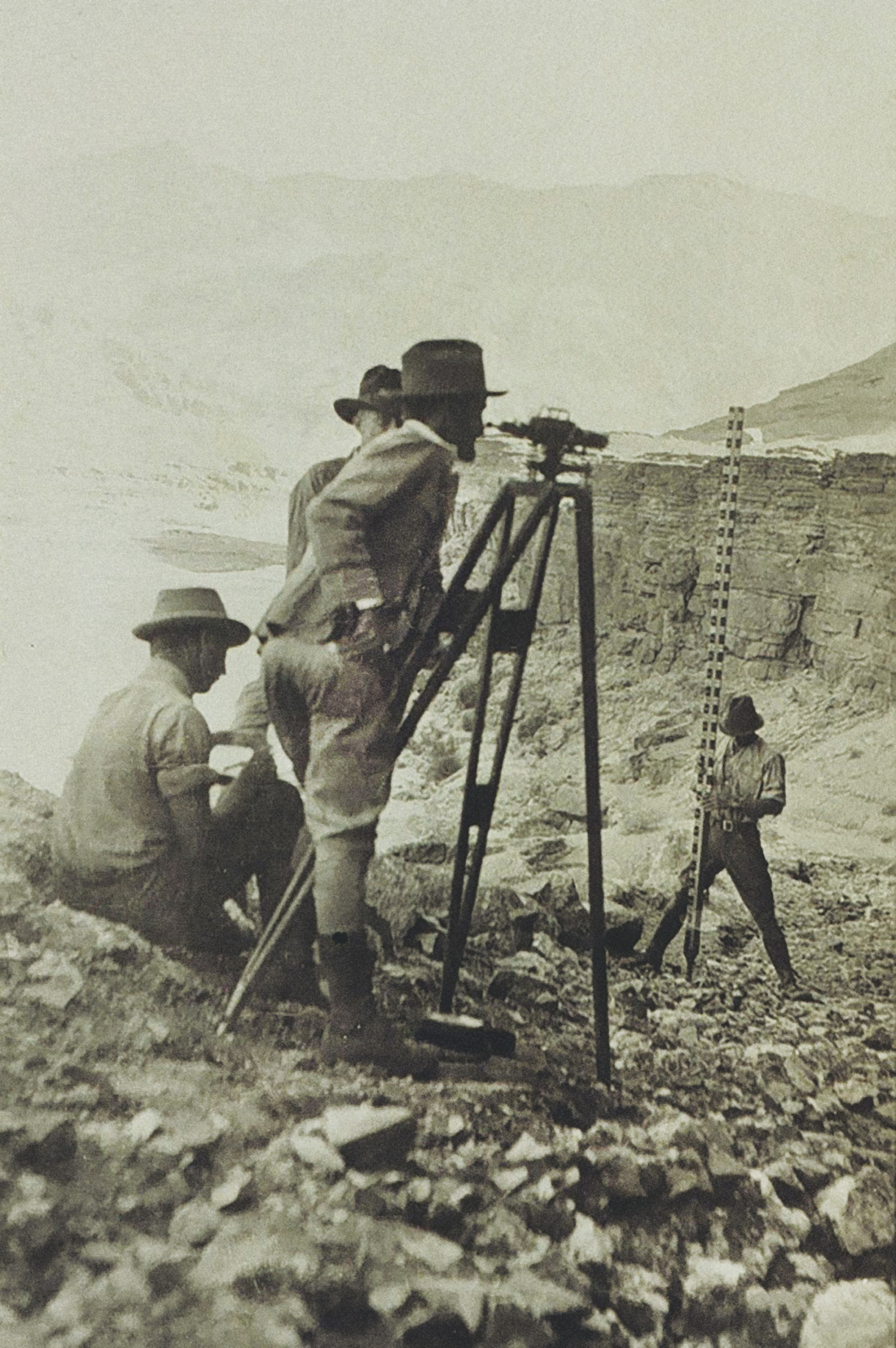 black and white image of surveyors with Fischer level