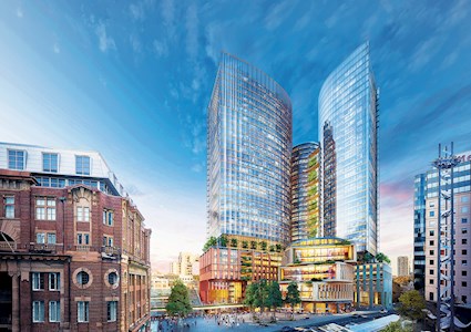 tall glass building with multiple wings sits atop multistoried residential and retail space