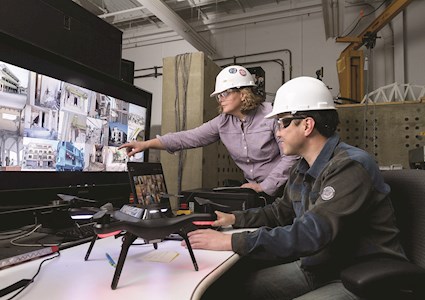 people pointing at computer screens