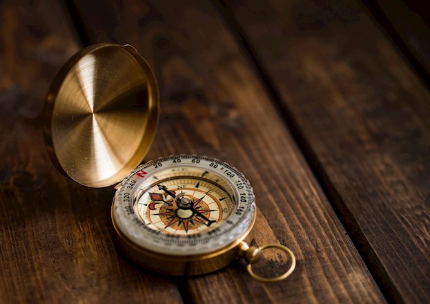 compass sitting on wood table