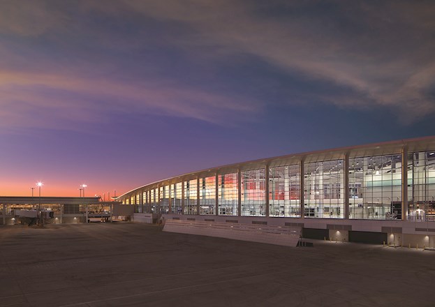 new airport terminal with large panes of glass to see the airplanes fly by