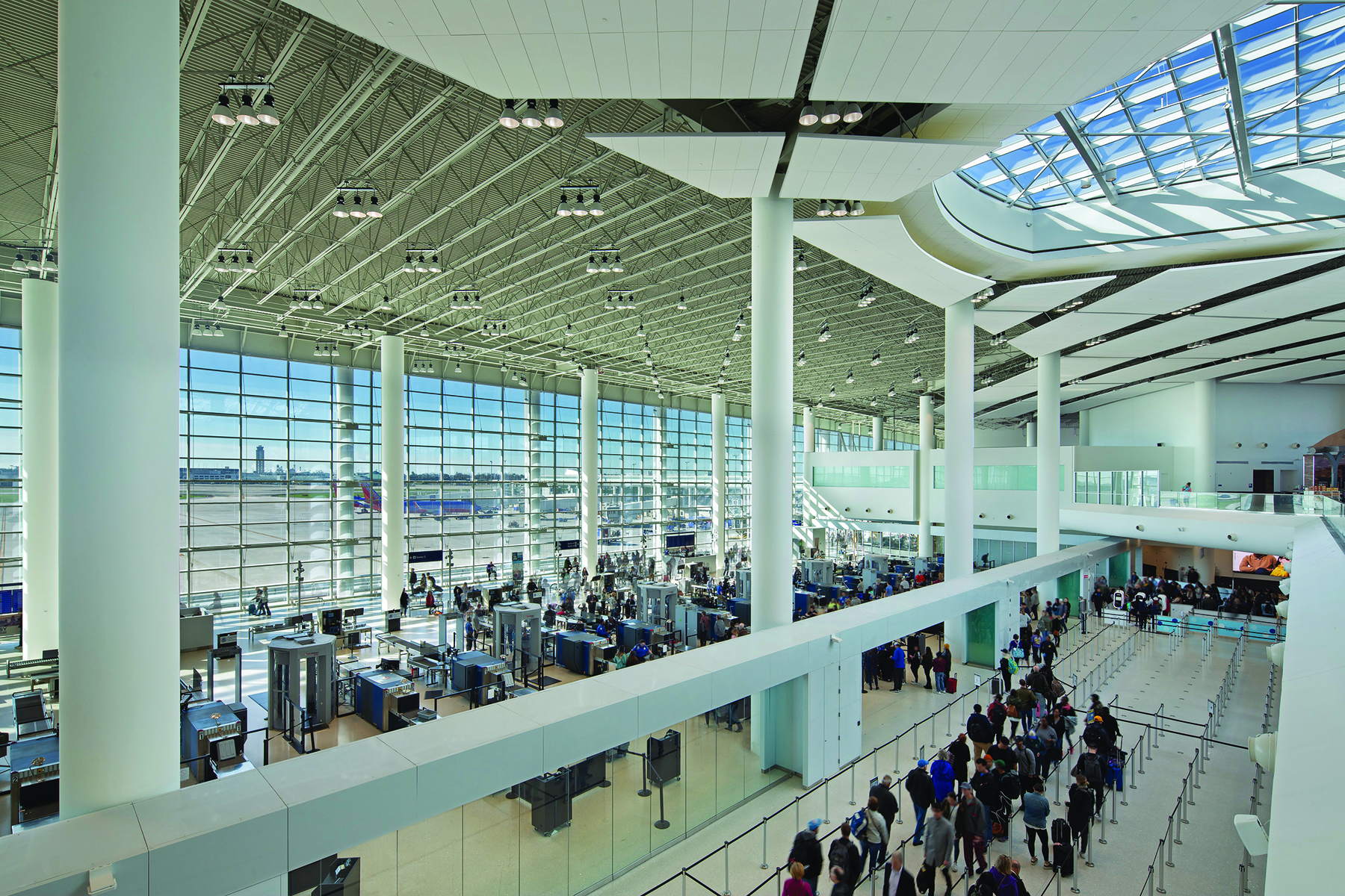 photo of new terminal at the Louis Armstrong New Orleans International Airport showing passengers queuing 