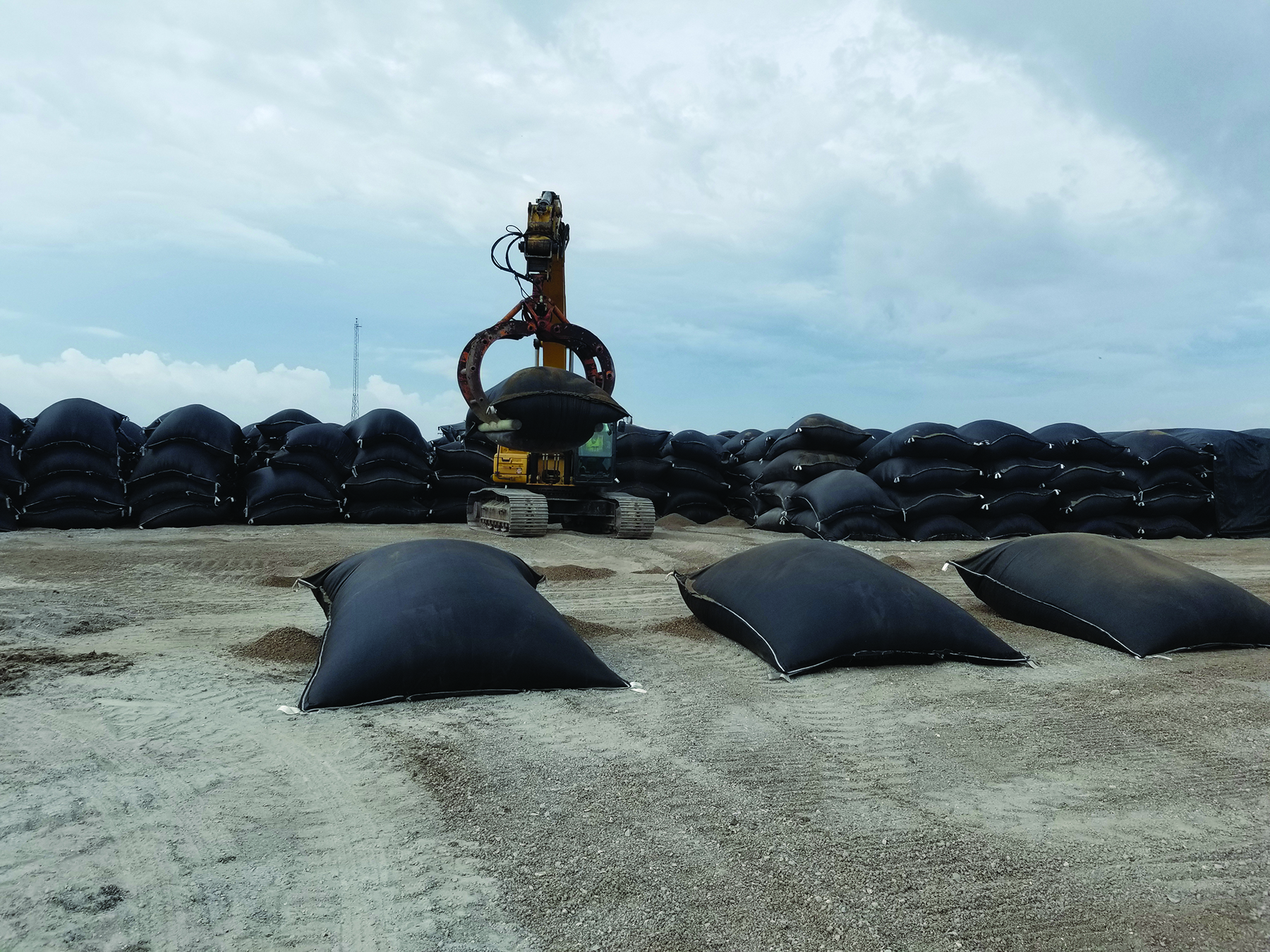 photo of bags filled with lightweight aggregate stacked to form the breakwater cores